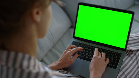 Hipster-using-laptop-chroma-key-screen-closeup.-Journalist-writing-article-home