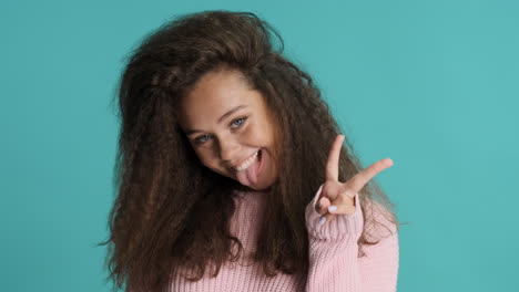 caucasian curly haired woman making funny faces in front of the camera.