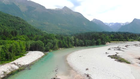 aerial view of river with mountains in background
