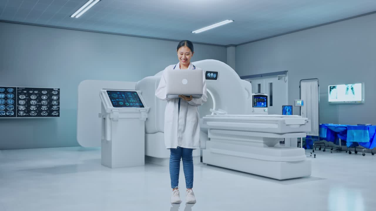 Full Body Of Asian Woman Doctor With Stethoscope Typing On A Laptop And Smiling With Mri Machine In The Hospital