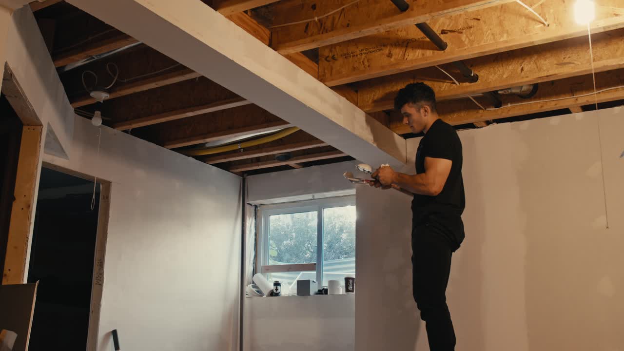 Builder Applying Joint Compound in Home Renovation