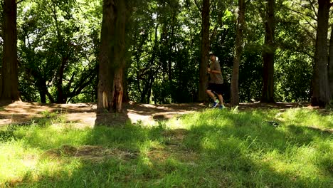 man jogging through the shadowy forest. side view