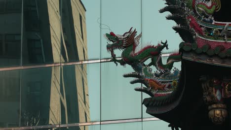 roof decorative sculptures at longshan temple with a modern building on the background