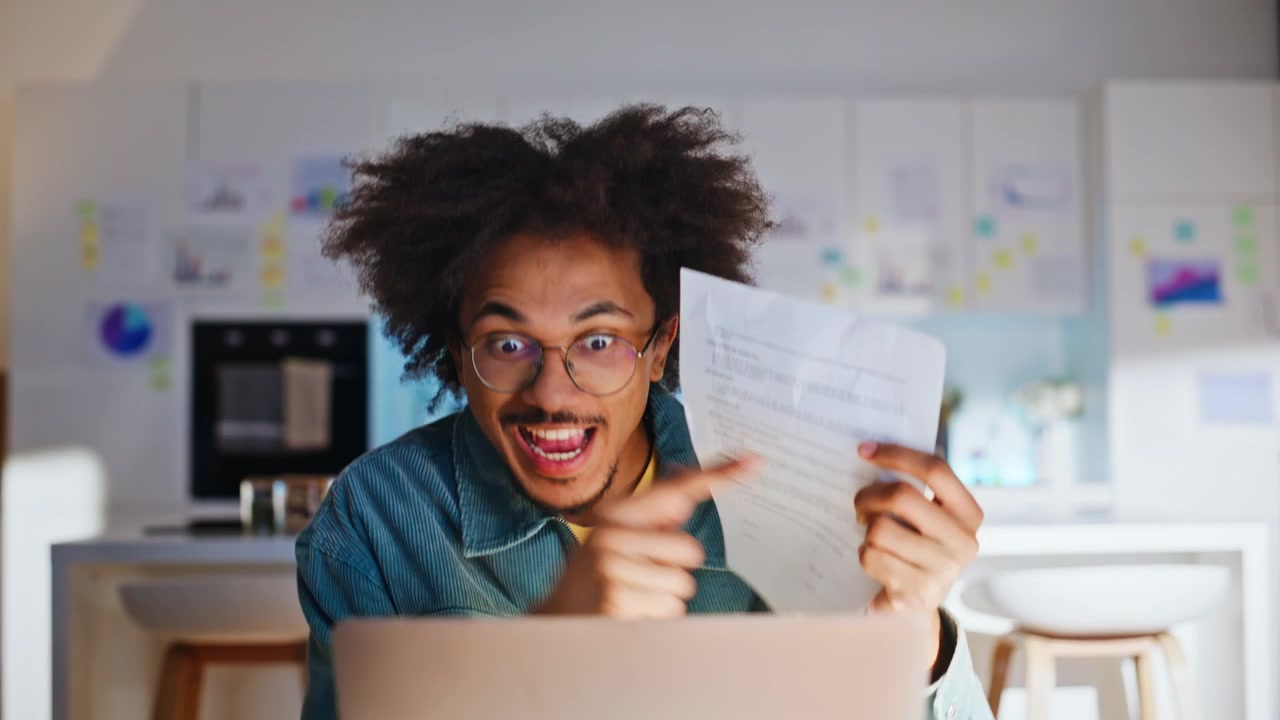 Remote worker reacting documents laptop video call. Disappointed man kitchen.