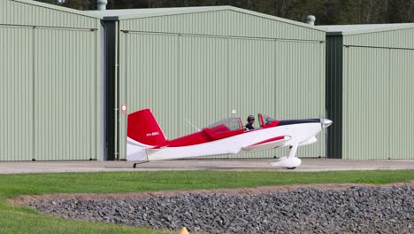 red and white plane moving on runway