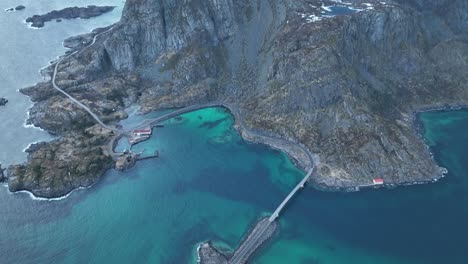 flying over lofoten reine mountain peaks overlooking picturesque wintry blue ocean