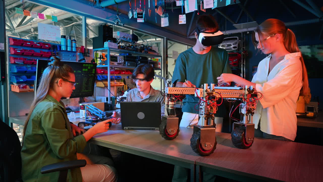 Group of teens doing experiments in robotics in a laboratory. Boys and girls in protective and VR glasses working with robots. Red and blue illumination