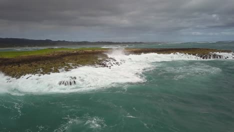 Aerial-view-of-crashing-waves-on-Mokuauia-Islet-Seabird-Sanctuary