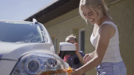 woman washing a white car