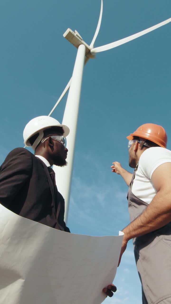 Engineers examining wind turbine plans