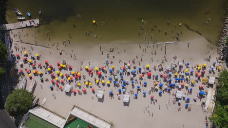 Static-overhead-aerial-of-Red-Beach,-Praia-Vermelha,-with-beach-goers-and-swimmers-on-a-hot-day-in-Rio-de-Janeiro