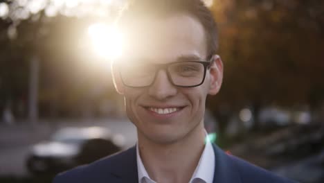 lifestyle portrait of young attractive caucasian salesman, businessman smiling happy into the camera. young businessman looking