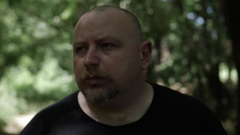 a man walking through forest trees