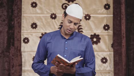 indian muslim man reading a book