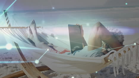 person relaxing in hammock on beach with digital network animation overlay