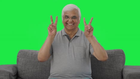 Happy-Indian-old-man-showing-victory-sign-Green-screen