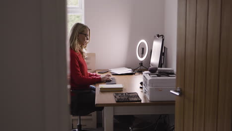 woman working at desk in home office