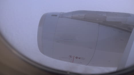 Looking-at-engine-and-clouds-from-inside-flying-plane