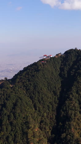 portrait aerial following the cableway of the chandragiri hill, kathmandu, nepal