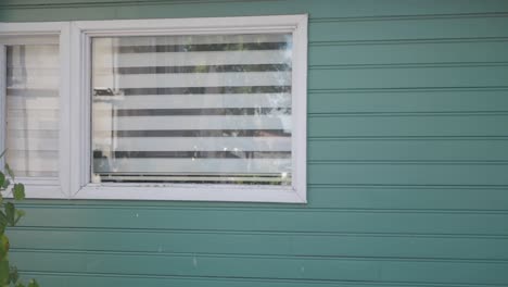 green house exterior with window and blinds
