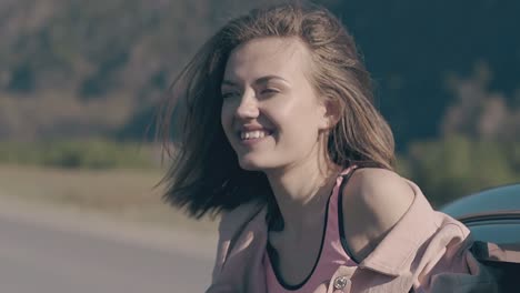 smiling-blonde-lady-with-perfect-teeth-leans-out-of-car