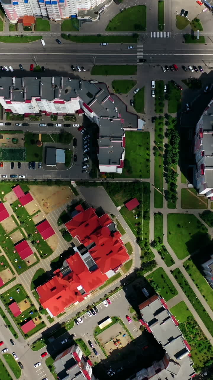 Cityscape from above. Modern downtown. Rooftops of architectural buildings in urban district. Motion camera to the right. Vertical video