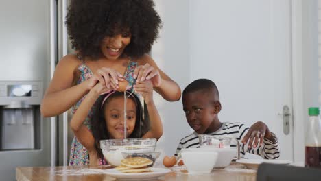 Video-of-african-american-family-cooking-together-in-the-kitchen