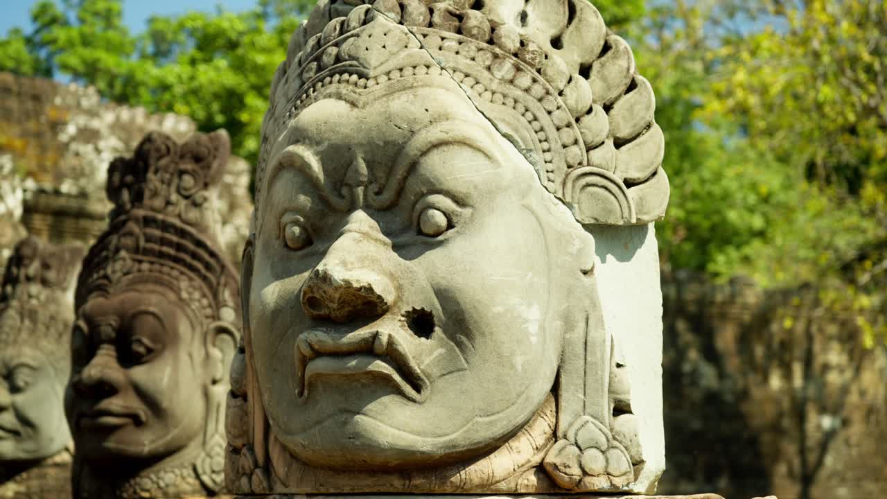 Close up view of an ancient statue in Angkor Thom, Siem Reap, Cambodia, visibly marked by bullet holes from the Cambodian Civil War and Khmer Rouge era.
