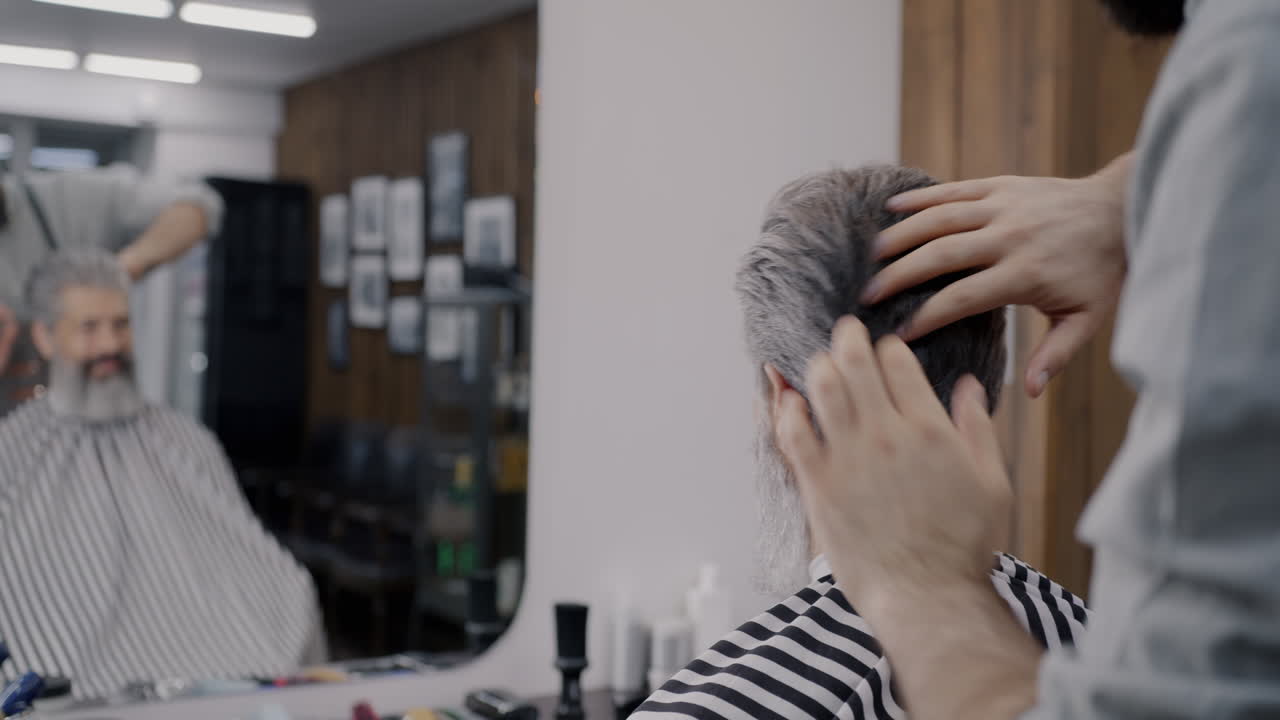 한 남자가 이발장에서 헤어스타일을 하고 있다.