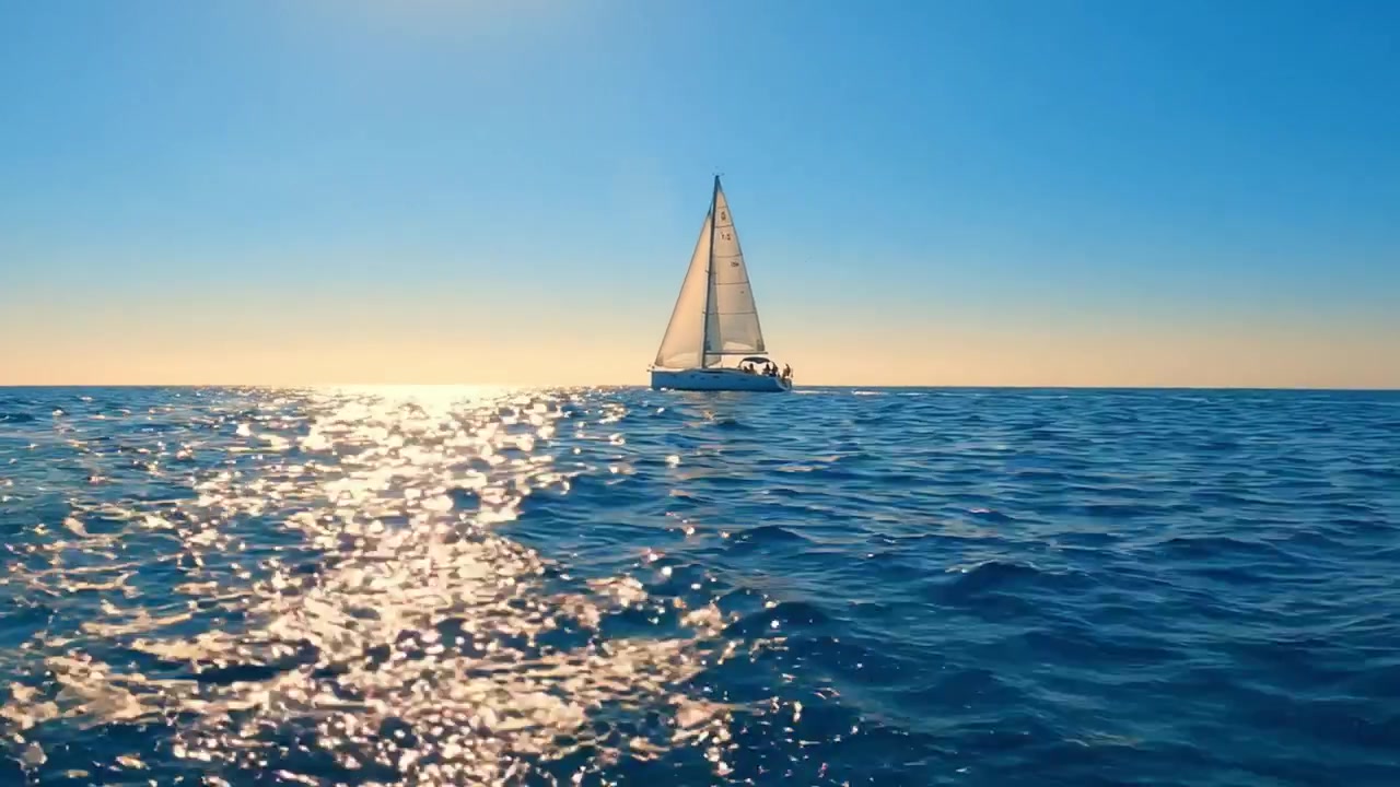 A Captivating View of a Sailboat Gliding Over Tranquil Waters Under a Brilliant Blue Sky, Capturing the Essence of Serenity and Adventure at Sea