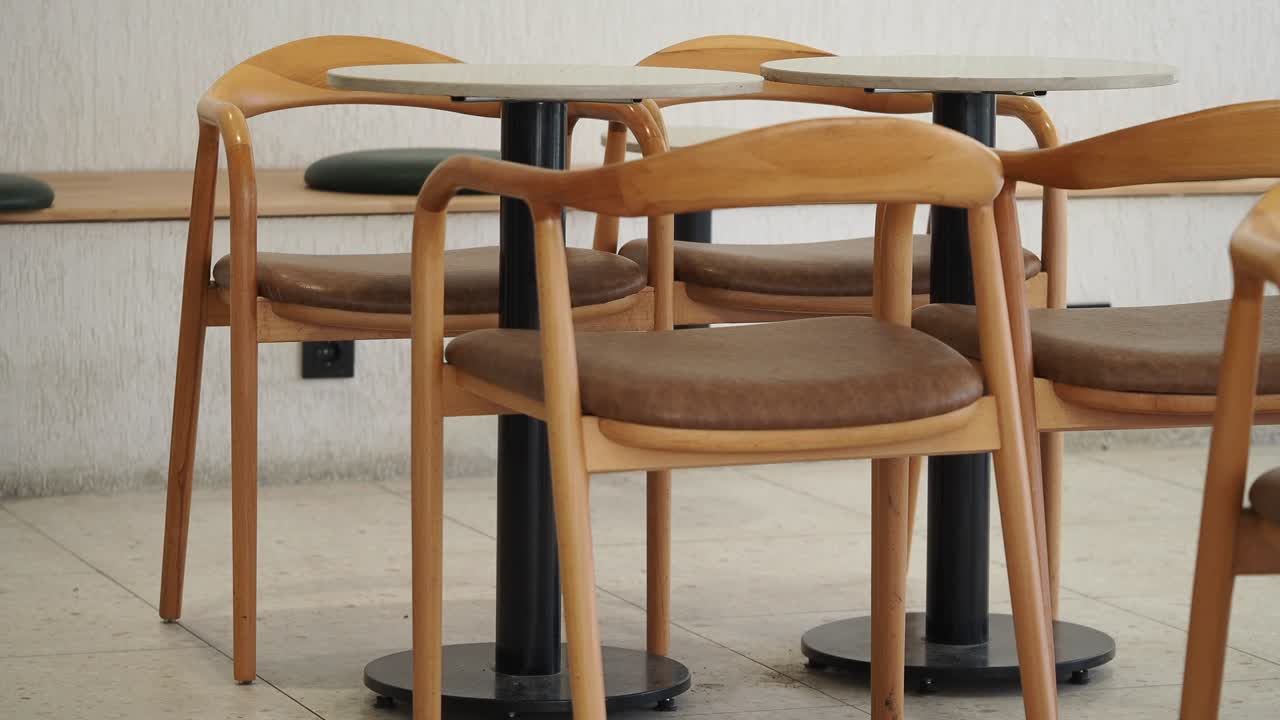 Empty Wooden Chairs and Tables in a Modern Cafe Interior