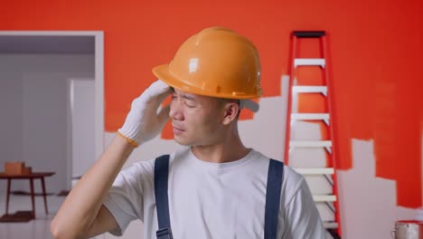 trabajador de la construcción con dolor de cabeza durante la renovación de la casa