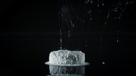 timelapse of grey medicine pill capsule dissolving in water like a decomposing drug capsule in stomach and instestines