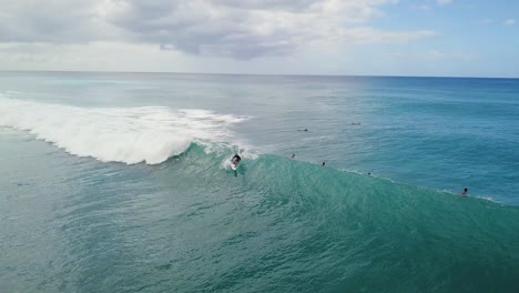 surfer stalls on take off on wave then pops off the back and returns to lineup