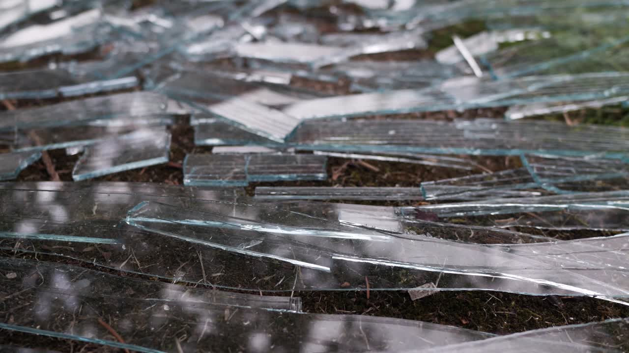 Pieces of broken glass lying on the ground, closeup