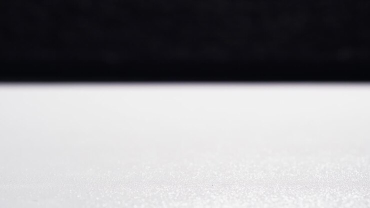 Loopable stop motion of coin stacks rising and falling in cycles on white surface