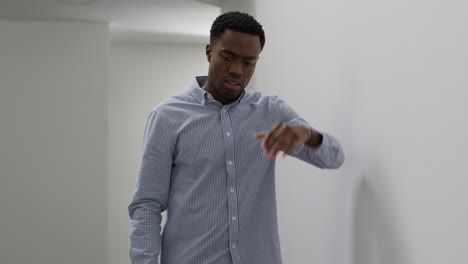 young businessman in office talking on mobile phone reacting to bad news looking unhappy and depressed 1