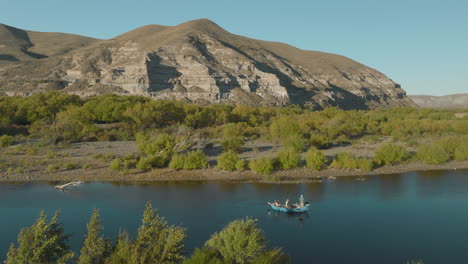 Stunning-aerial-view-of-a-Fly-Fishing-Drift-Boat-down-the-Chimehuin-river-in-Argentina