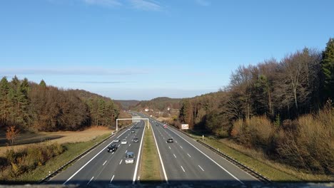 view from a bridge down to the german autobahn with many cars passing