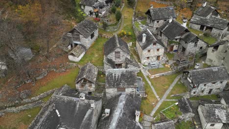 Flying-above-the-village-of-Cavergno,-situated-in-the-district-of-Vallemaggia,-by-the-border-of-Italy,-in-the-canton-of-Ticino-in-Switzerland