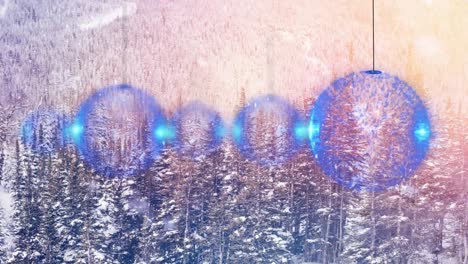 animation of snow falling over christmas baubles in winter landscape