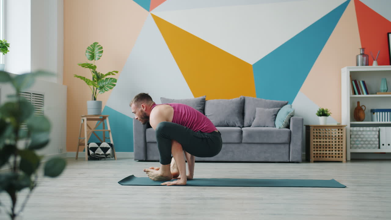 Man Performing a Yoga Handstand Pose at Home