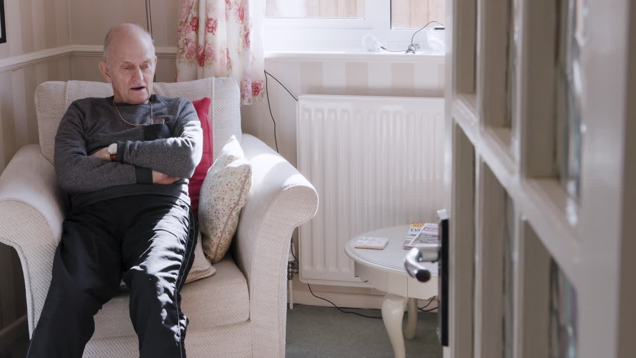 Senior man relaxing in armchair at home