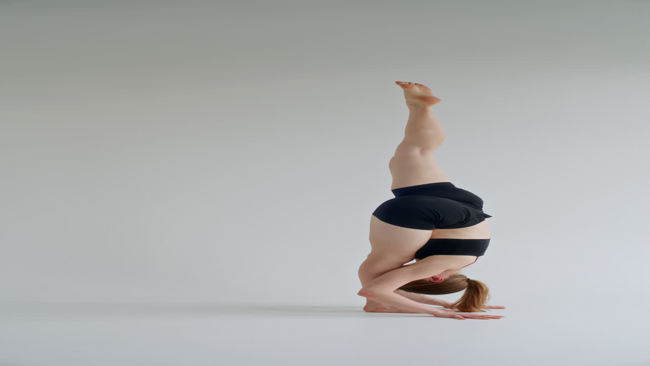 Young Woman Performing Standing Split Pose during Yoga Practice