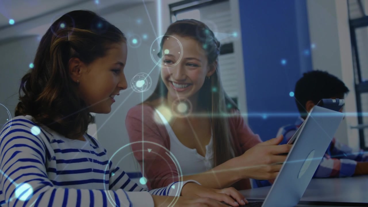 Animation of network of connections over happy caucasian girls using laptop at school