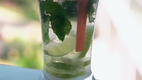 macro frozen mojito in glass stands on white surface