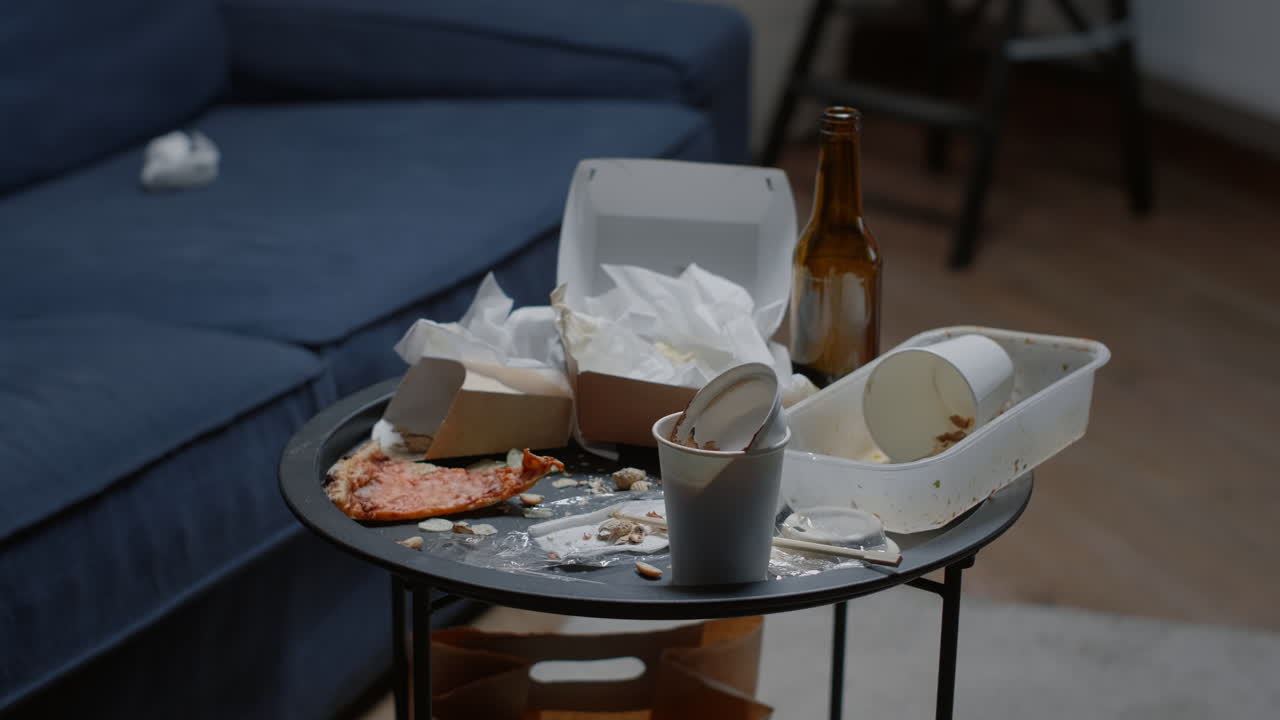 Close up of leftover food on table in empty messy living room