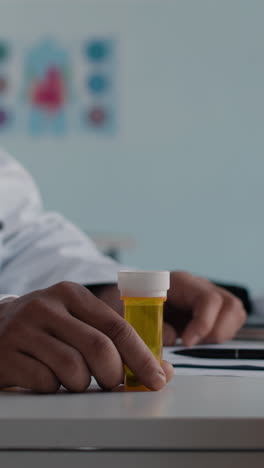 a doctor holding a bottle of pills