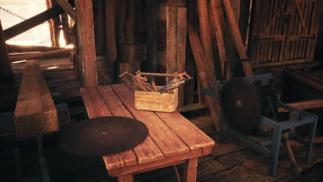 rustic workshop tools on a wooden table in a sunlit barn