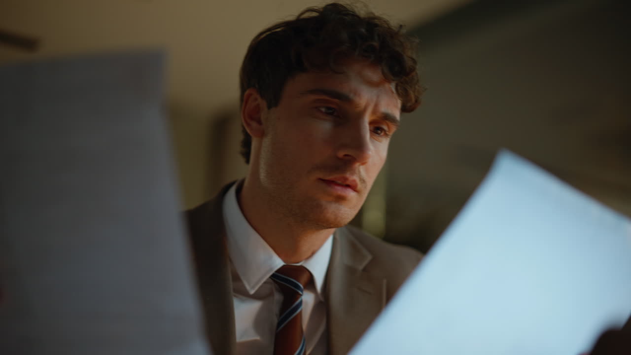 Businessman hand checking documents finding mistake at night buro desk closeup